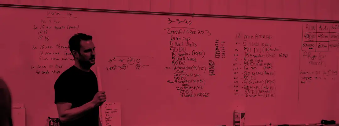 A coach at the whiteboard before a class